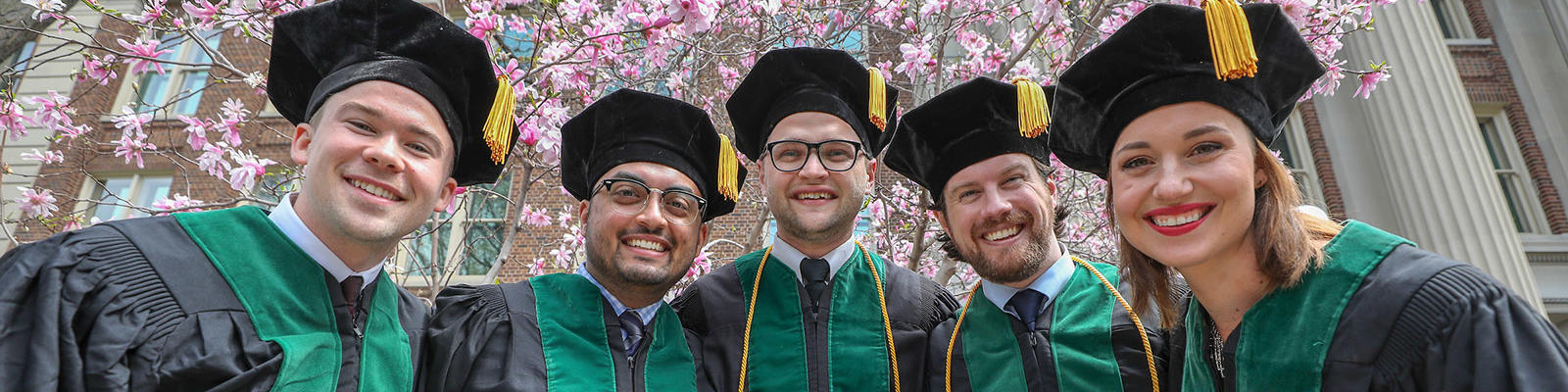 Five graduates in doctoral robes