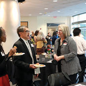 ICGC Director Karen Brown talks with others at the spring dinner.